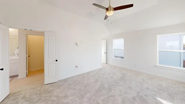 an empty room with closet and windows
