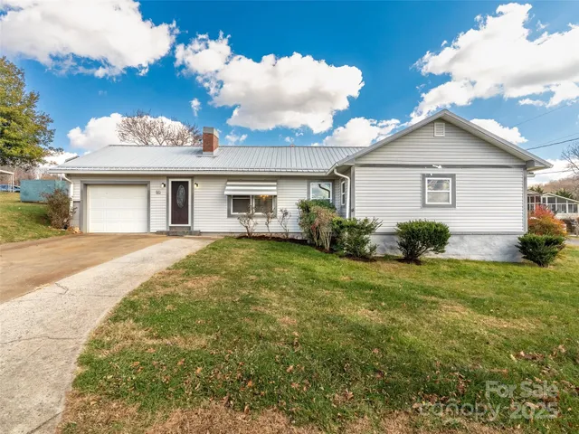 a view of a house with a backyard