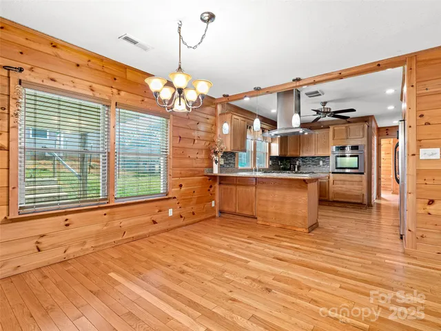 a kitchen with stainless steel appliances granite countertop a sink and cabinets