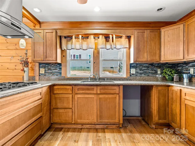 a kitchen with stainless steel appliances granite countertop a stove and a sink