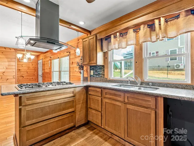 a kitchen with stainless steel appliances granite countertop a refrigerator and a stove