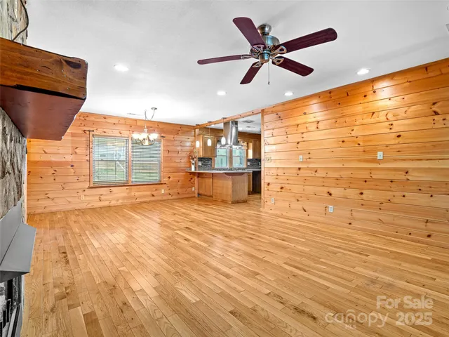 a view of a livingroom with a ceiling fan and wooden floor