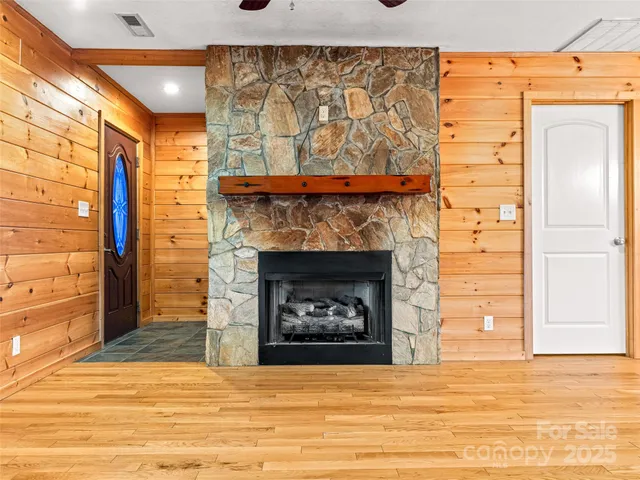 a view of an empty room with a fireplace and a window