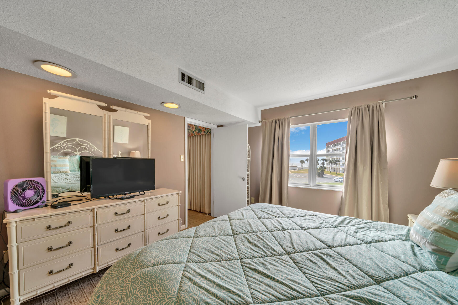 909 Santa Rosa Boulevard, Unit 138 Fort Walton Beach, FL 32548 - Photo 17 of 27 a bedroom with a bed and a flat screen tv