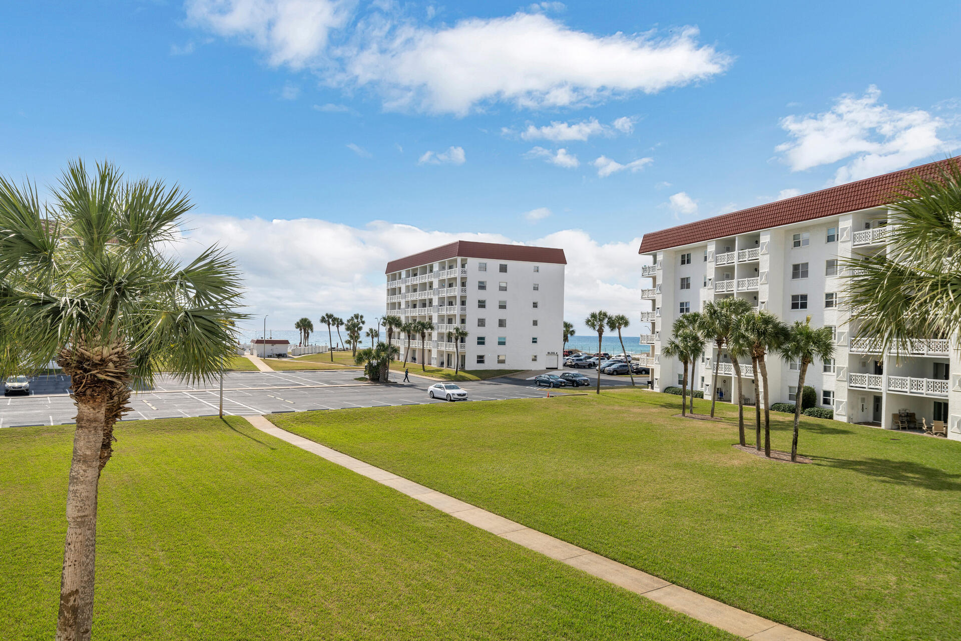 909 Santa Rosa Boulevard, Unit 138 Fort Walton Beach, FL 32548 - Photo 3 of 27 a view of swimming pool of water with lawn chairs and large trees