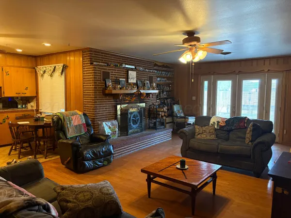 a living room with furniture a ceiling fan and a window