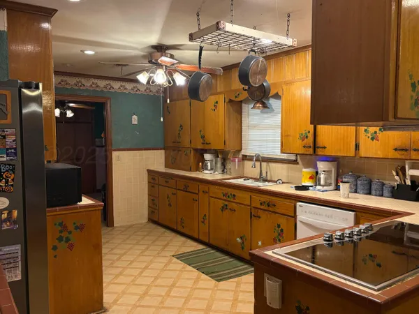 a kitchen with a sink appliances and cabinets