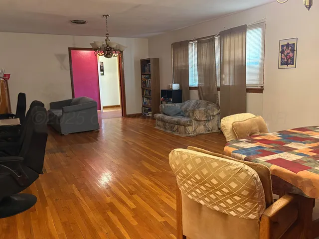 a bedroom with furniture and a wooden floor