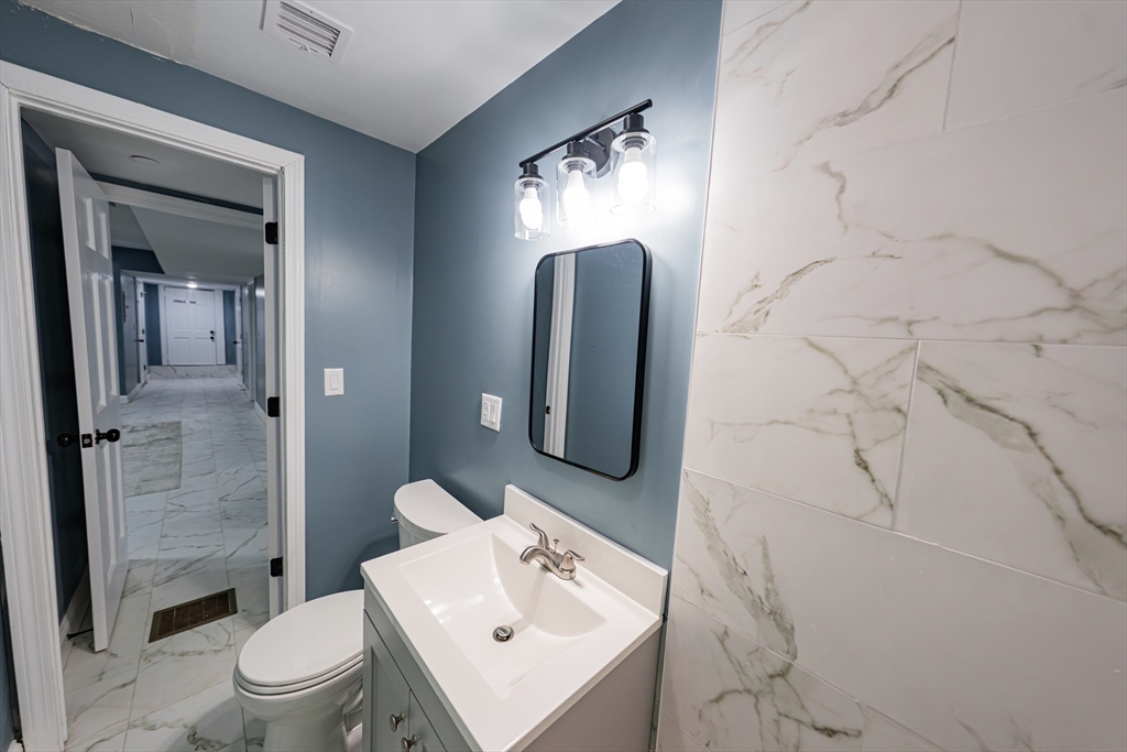 24 Tudor Street Chelsea, MA 02150 - Photo 16 of 36 a bathroom with a toilet sink and shower