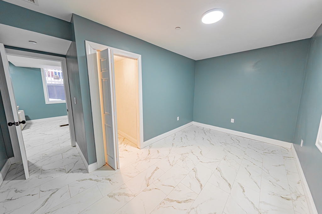 24 Tudor Street Chelsea, MA 02150 - Photo 18 of 36 an empty room with a bathroom