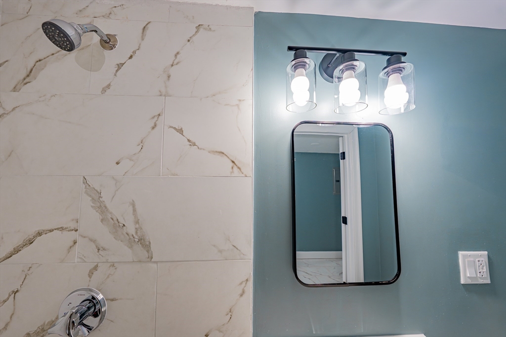 24 Tudor Street Chelsea, MA 02150 - Photo 20 of 36 a bathroom with a mirror