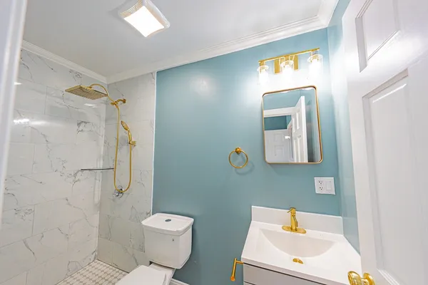 a bathroom with a sink toilet and shower