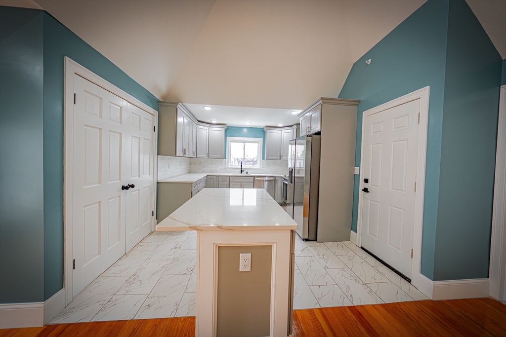 24 Tudor Street Chelsea, MA 02150 - Photo 30 of 36 a kitchen with stainless steel appliances granite countertop a refrigerator and a sink
