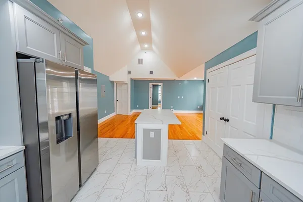 a kitchen with stainless steel appliances granite countertop a refrigerator and a sink
