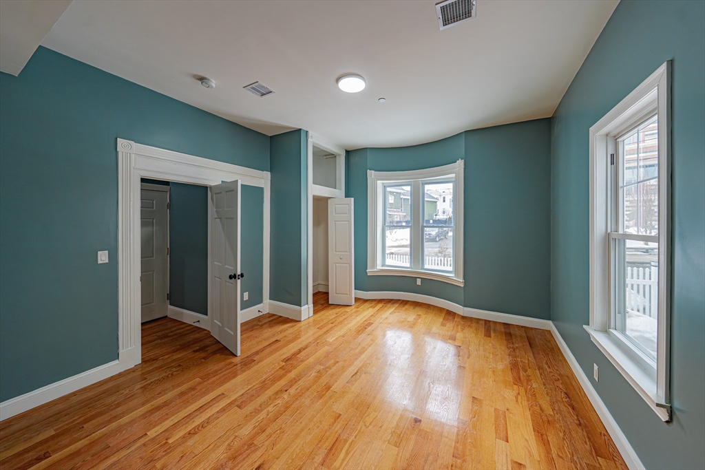 24 Tudor Street Chelsea, MA 02150 - Photo 5 of 36 a view of an empty room with glass door and wooden floor