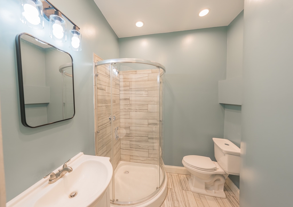 24 Tudor Street Chelsea, MA 02150 - Photo 6 of 36 a bathroom with a toilet a sink and mirror
