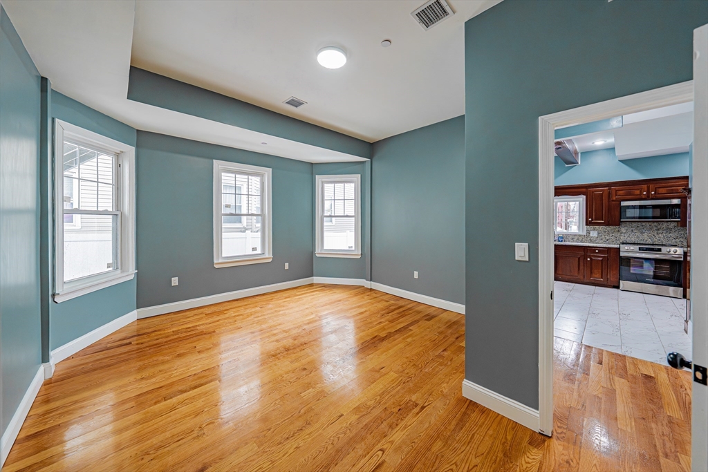 24 Tudor Street Chelsea, MA 02150 - Photo 10 of 36 a view of an empty room with window and wooden floor