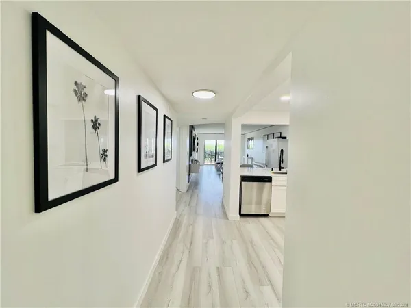 a kitchen with white cabinets and appliances
