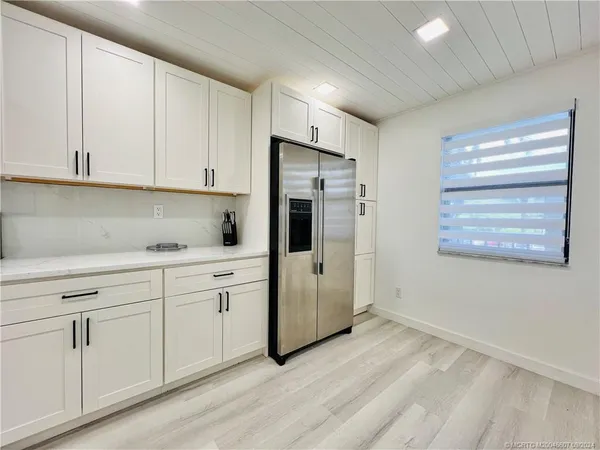 a kitchen with a sink and white cabinets