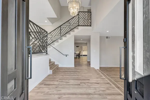 a view of entryway and hall with wooden floor