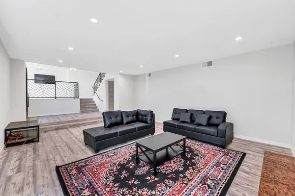 a living room with furniture rug and window