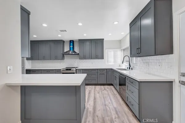 a kitchen with a sink a stove and cabinets