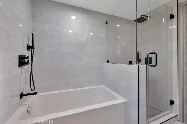 a bathroom with a bathtub and a shower