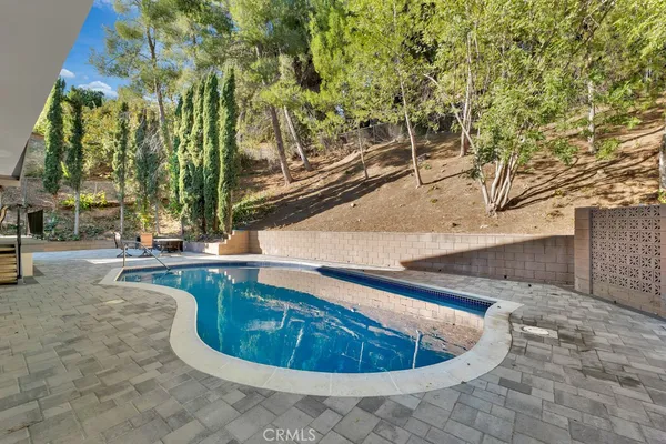 a view of a swimming pool with sitting area