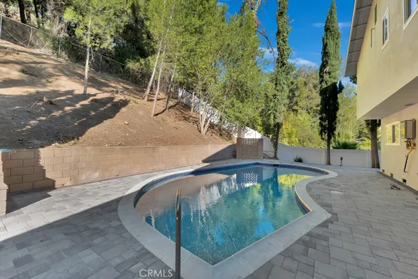 a view of a swimming pool with a yard