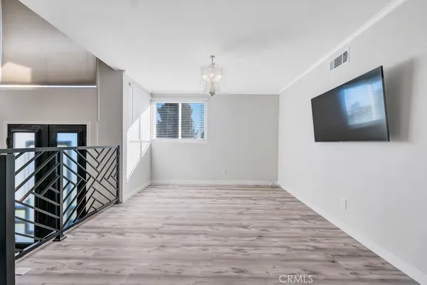 a view of livingroom with wooden floor and a flat screen tv
