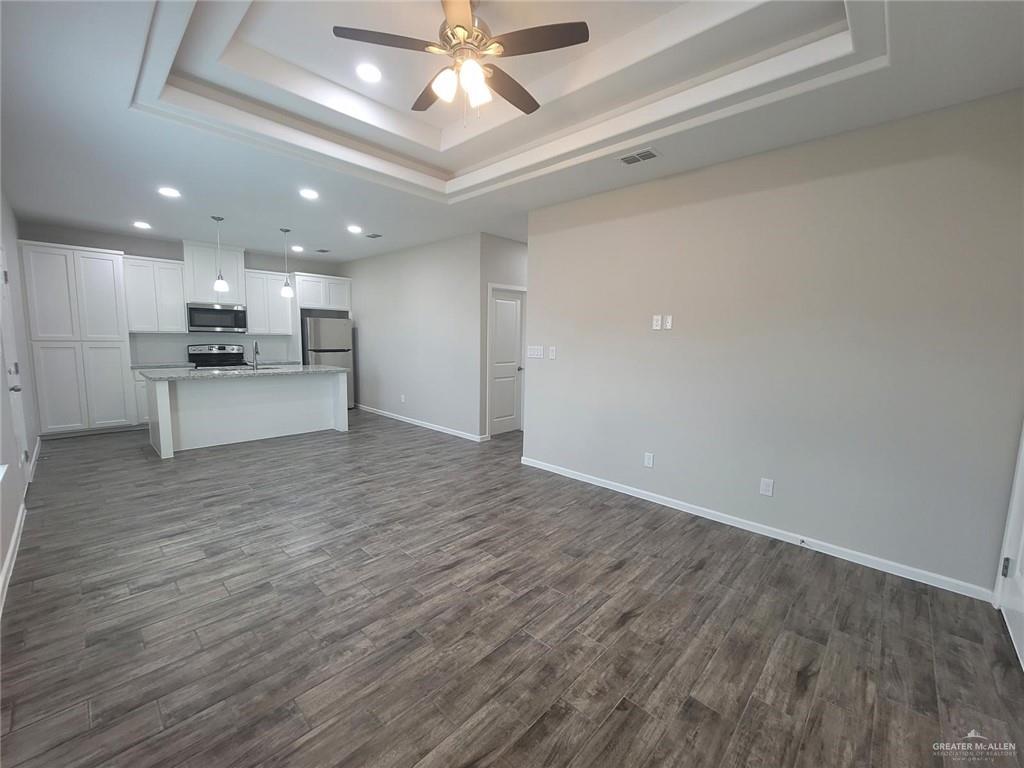 5805 Swallow Avenue, Unit 4 Mission, TX 78573 - Photo 11 of 19 a large kitchen with a large counter top appliances and cabinets