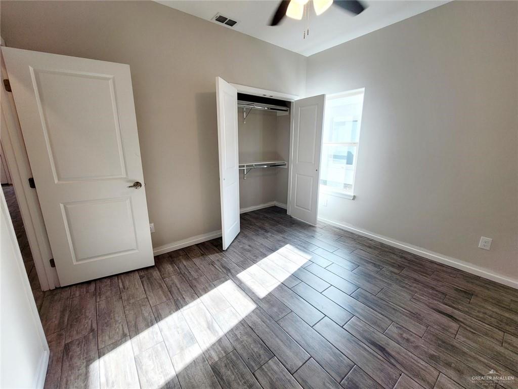 5805 Swallow Avenue, Unit 4 Mission, TX 78573 - Photo 13 of 19 wooden floor in an empty room with a window