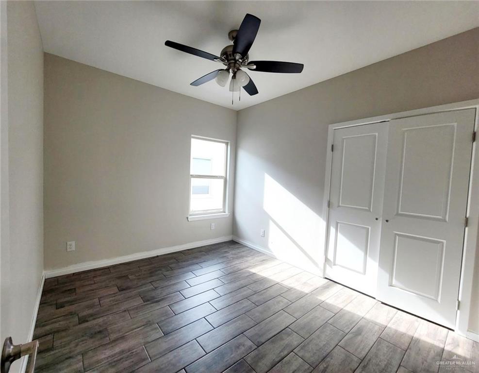5805 Swallow Avenue, Unit 4 Mission, TX 78573 - Photo 14 of 19 a view of empty room with wooden floor and fan