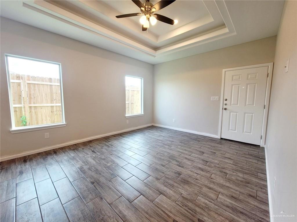 5805 Swallow Avenue, Unit 4 Mission, TX 78573 - Photo 15 of 19 wooden floor in an empty room with a window