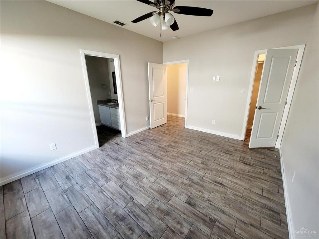 5805 Swallow Avenue, Unit 4 Mission, TX 78573 - Photo 16 of 19 wooden floor in an empty room with a window