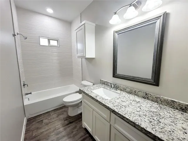 a bathroom with a toilet and shower