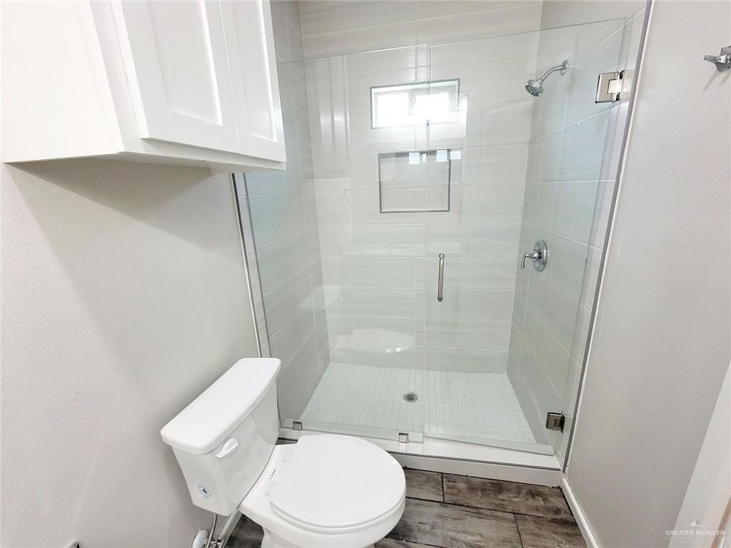 5805 Swallow Avenue, Unit 4 Mission, TX 78573 - Photo 18 of 19 a bathroom with a toilet and shower