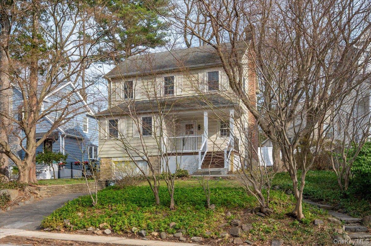 a front view of a house with a garden