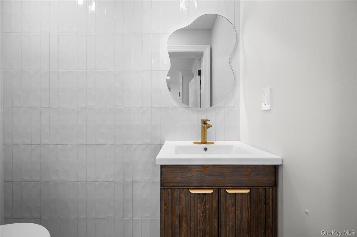 28 Cross Street Bronxville, NY 10708 - Photo 11 of 34 a bathroom with a sink and a mirror