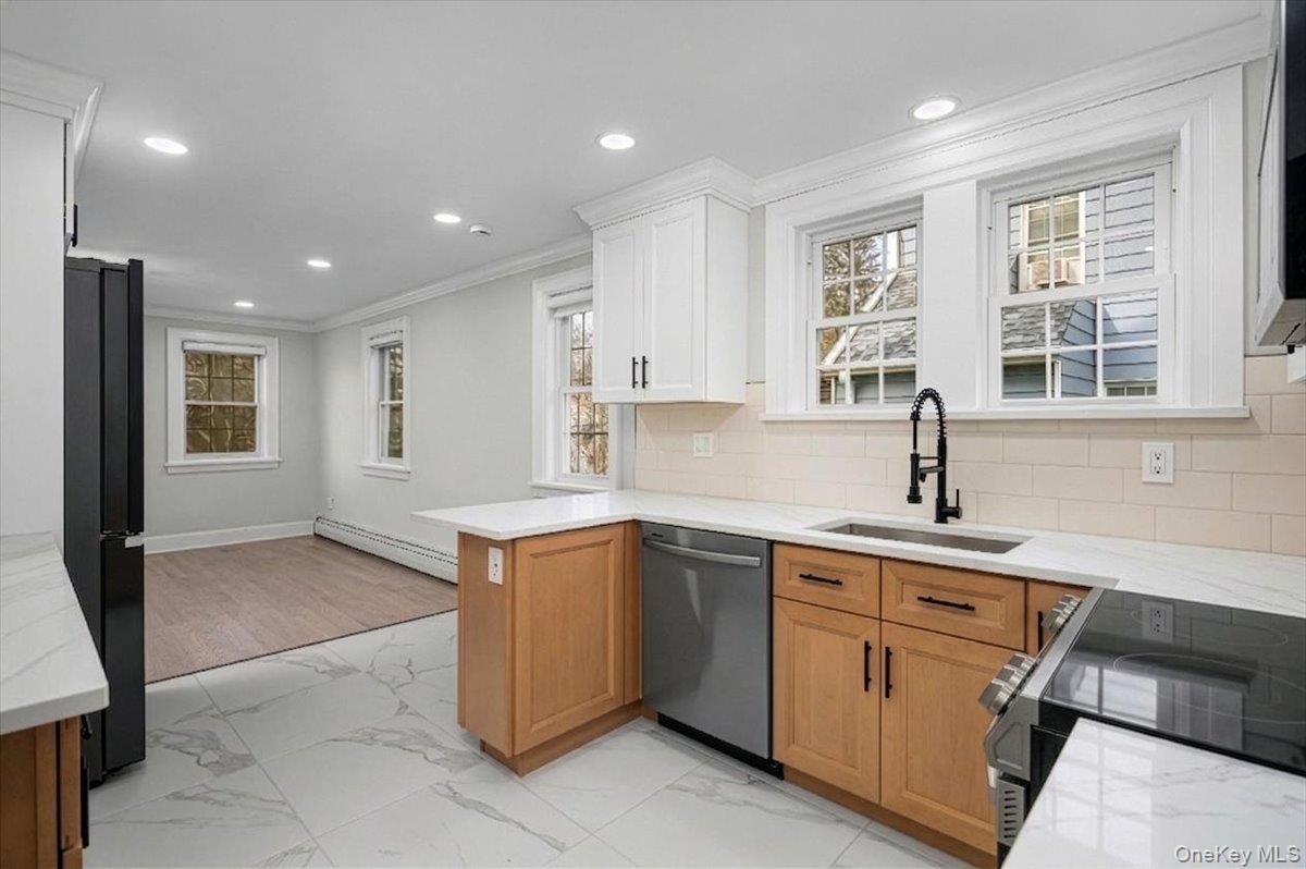 28 Cross Street Bronxville, NY 10708 - Photo 13 of 34 a kitchen with a sink window and cabinets