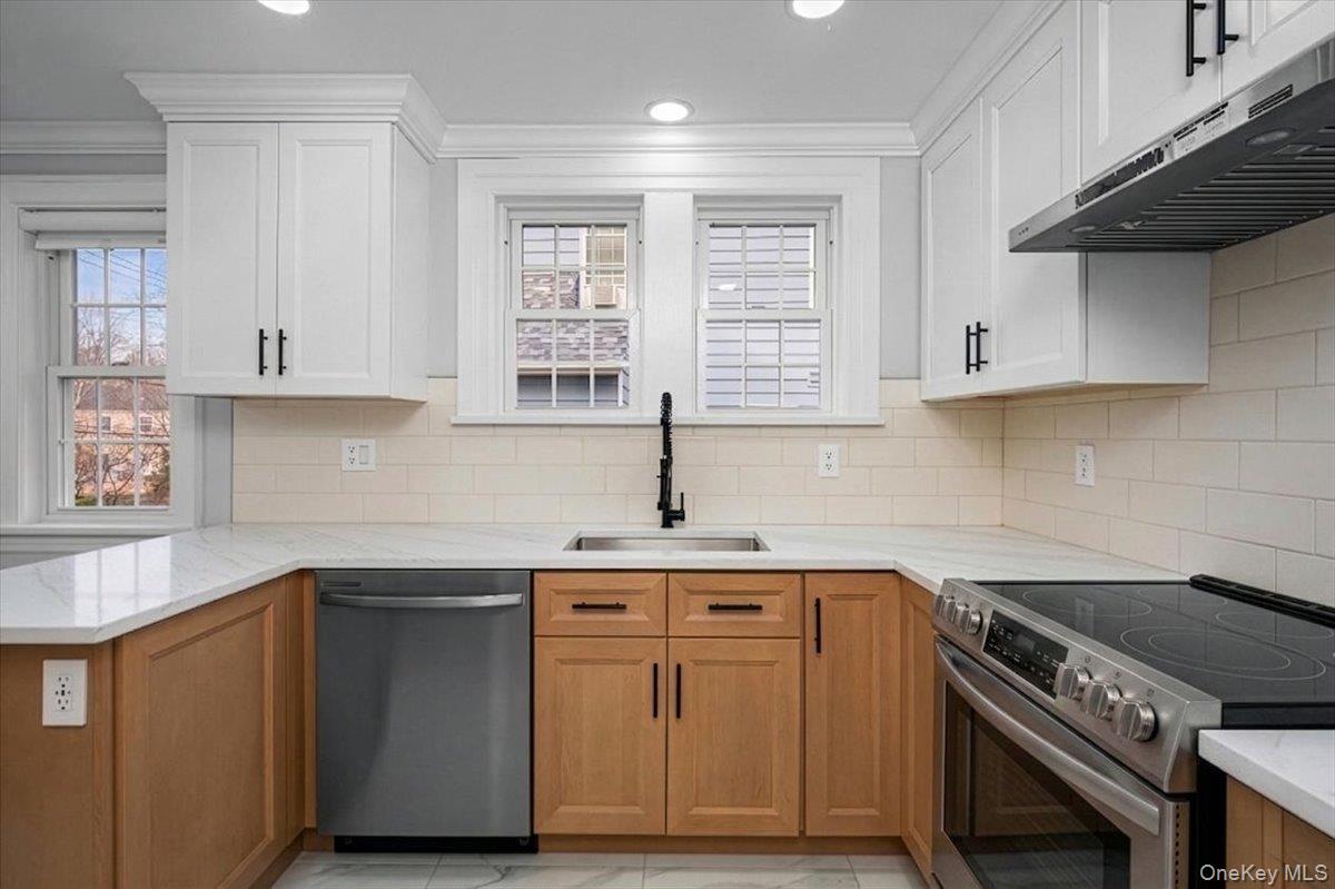 28 Cross Street Bronxville, NY 10708 - Photo 14 of 34 a kitchen with stainless steel appliances granite countertop a sink stove and cabinets