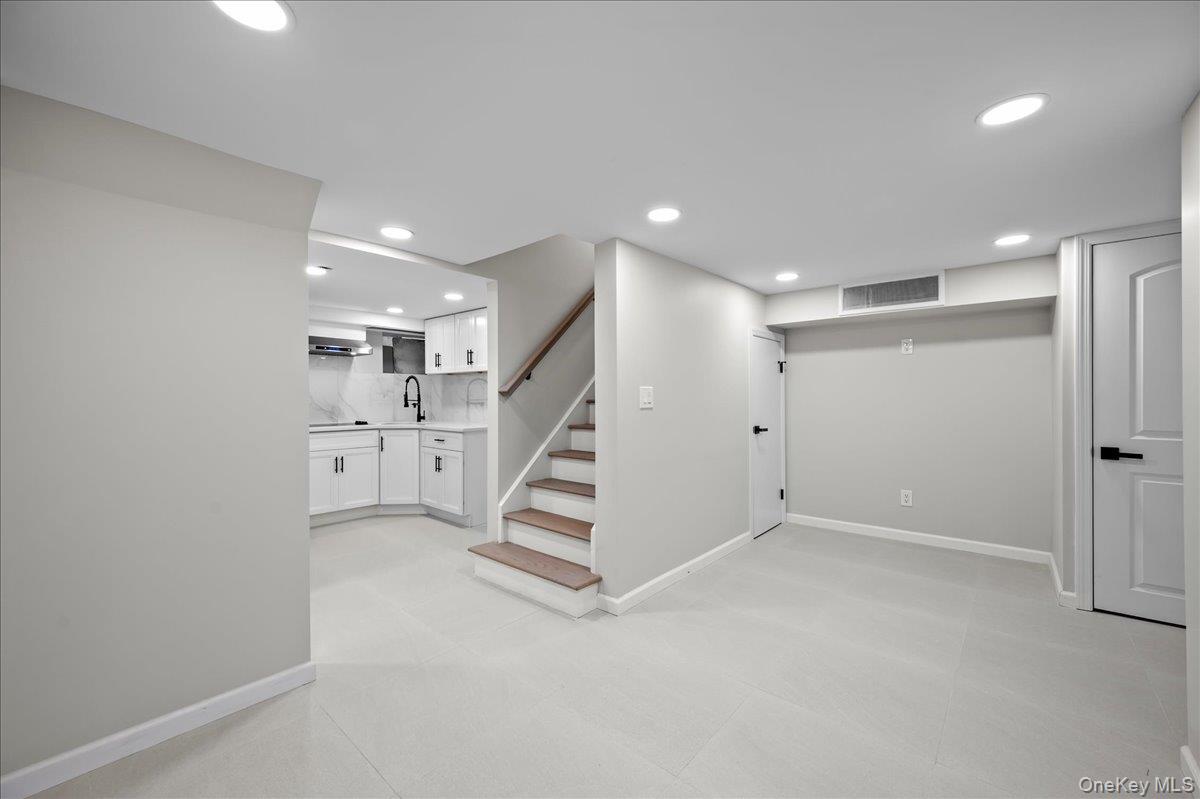 28 Cross Street Bronxville, NY 10708 - Photo 20 of 34 an empty room with white walls and stairs