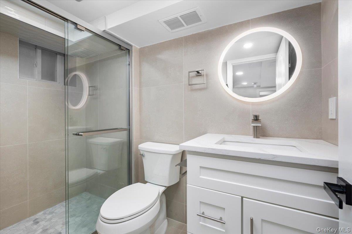 28 Cross Street Bronxville, NY 10708 - Photo 23 of 34 a bathroom with a sink mirror vanity and toilet