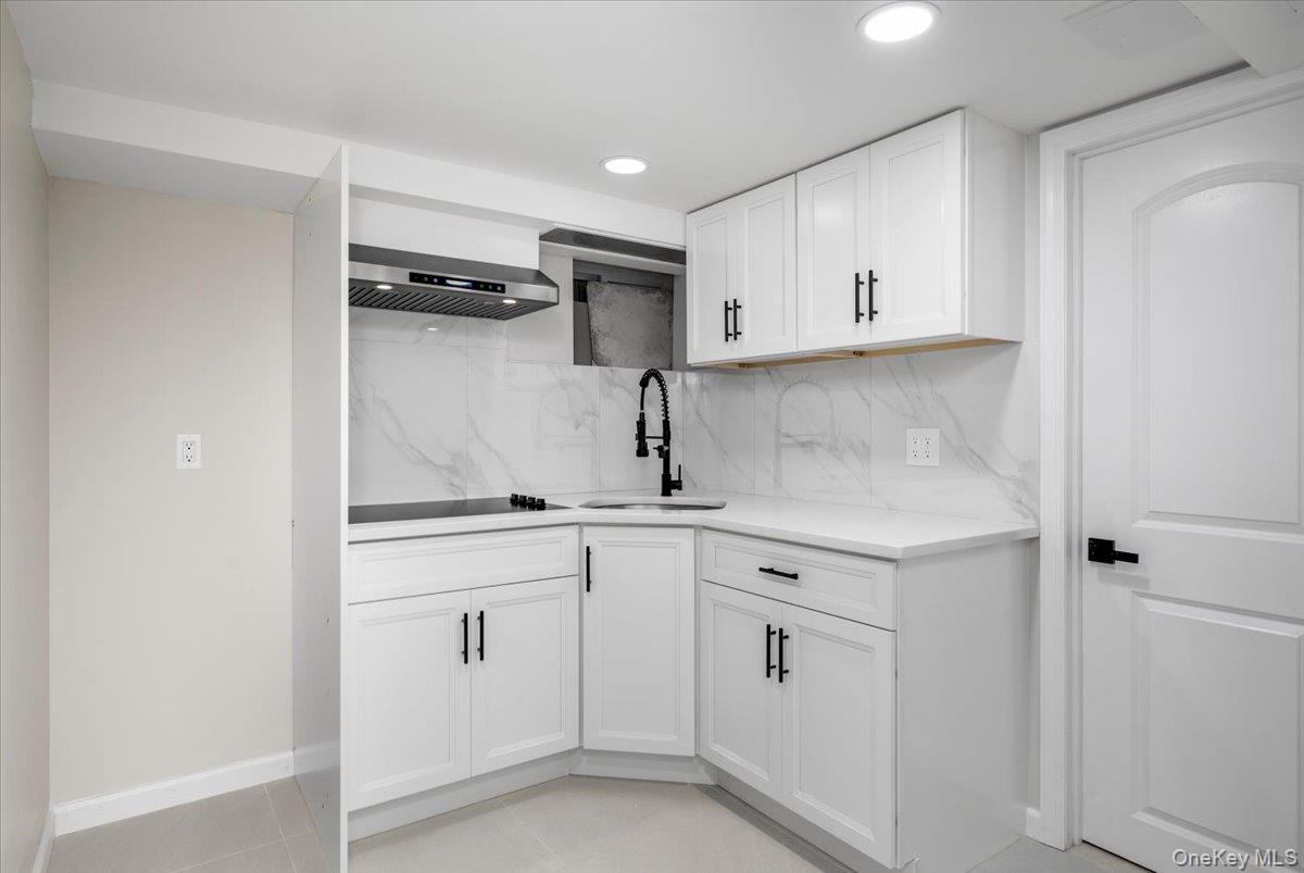 28 Cross Street Bronxville, NY 10708 - Photo 24 of 34 a kitchen with white cabinets and sink