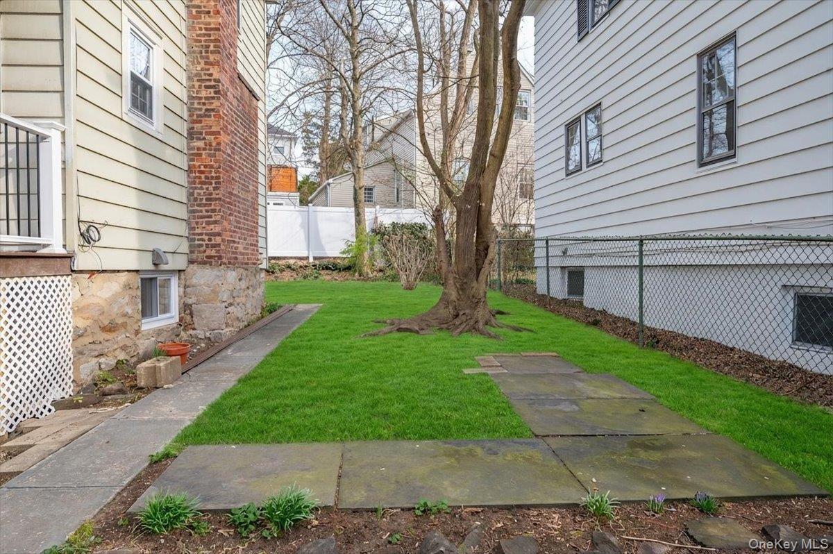 28 Cross Street Bronxville, NY 10708 - Photo 26 of 34 a front view of a house with a yard
