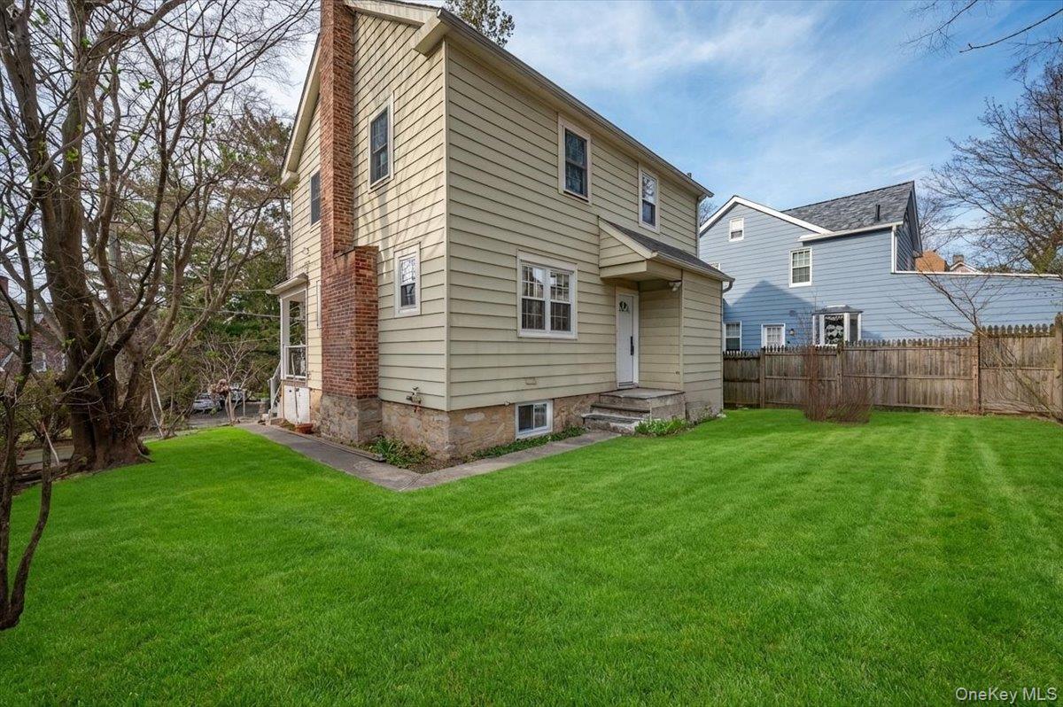 28 Cross Street Bronxville, NY 10708 - Photo 30 of 34 a view of a backyard with plants and large tree