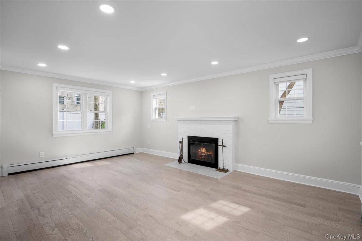 28 Cross Street Bronxville, NY 10708 - Photo 4 of 34 an empty room with windows and fireplace