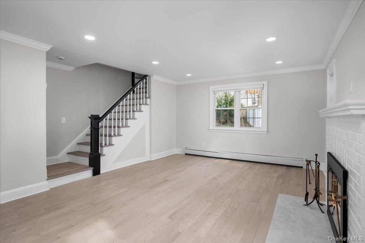 28 Cross Street Bronxville, NY 10708 - Photo 5 of 34 a view of an empty room with a window and wooden floor