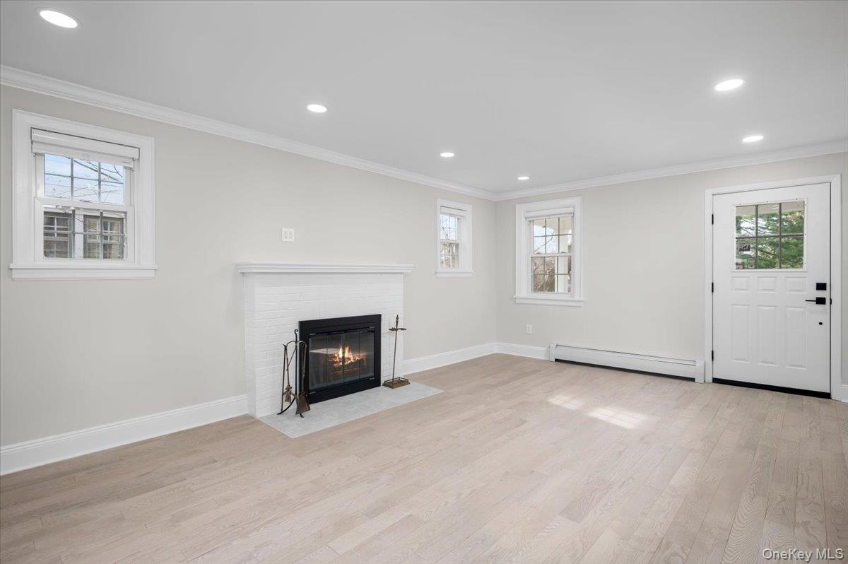 28 Cross Street Bronxville, NY 10708 - Photo 6 of 34 an empty room with windows and fireplace
