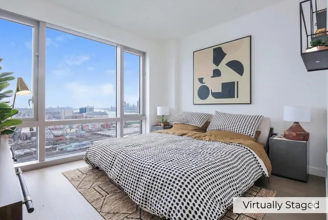 a bedroom with a bed and glass wall painting